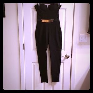 Black sleeveless mid calf jumpsuit  gold belt.